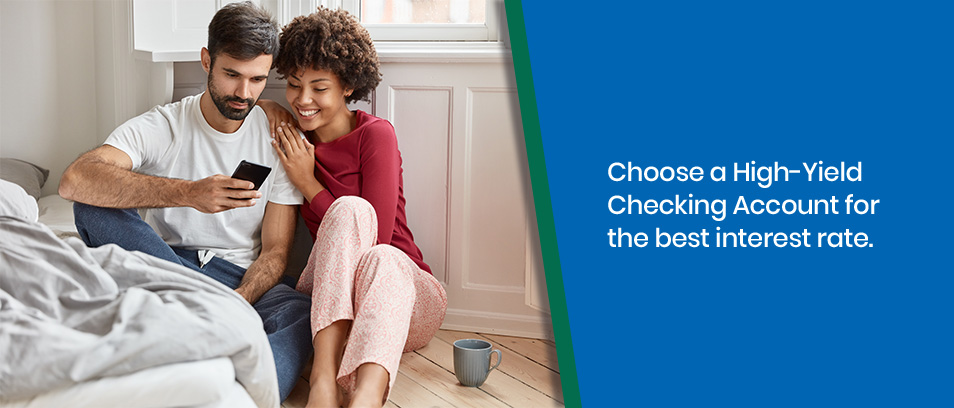 Choose a High-Yield Checking Account for the best interest rate - Couple looking at a cell phone
